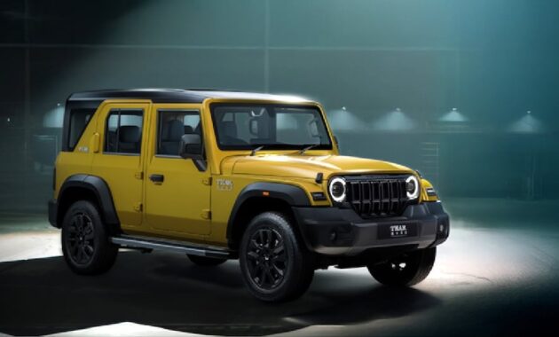 mahindra thar roxx star edition yellow black paint theme front three quarters